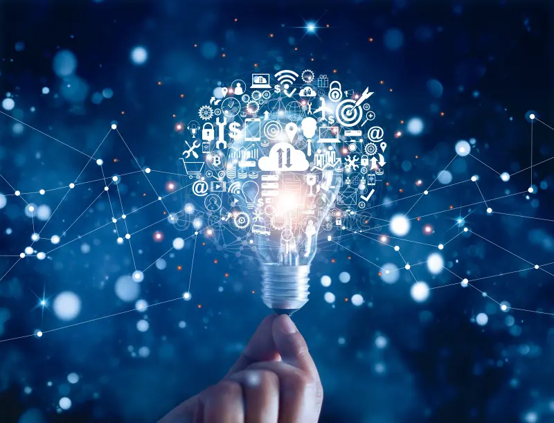 A person holds a light bulb, which emits a glowing light surrounded by various digital icons representing technology and communication. The background features a blue gradient with abstract connections, emphasizing innovation and creativity.