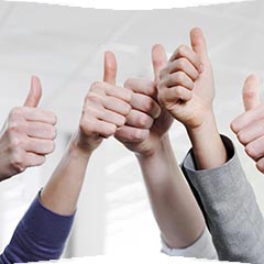 A group of hands is raised, all displaying a thumbs-up gesture, signifying approval or encouragement. The hands come from diverse skin tones and are positioned against a neutral background, creating a positive and supportive atmosphere.