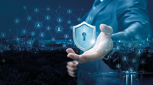 A business professional extends a hand, presenting a digital shield with a keyhole symbol. Behind him, a network of interconnected nodes represents security and connectivity, emphasizing the importance of cybersecurity in a modern, technological landscape.