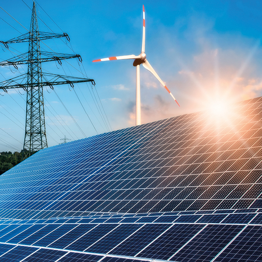 A solar panel array is prominently featured in the foreground, reflecting sunlight. In the background, a wind turbine stands against a clear blue sky. A high-voltage power line runs beside them, symbolizing renewable energy sources working together.